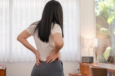 woman-with-back-pain-holding-lower-back